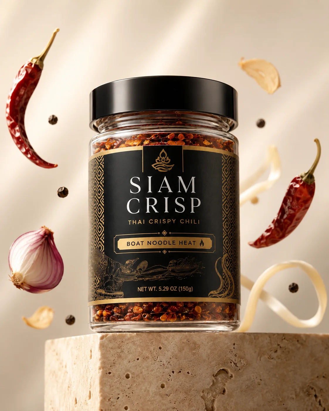 Siam Crisp Boat Noodle Heat jar surrounded by floating dried chili, shallot, garlic, pepper, and noodles